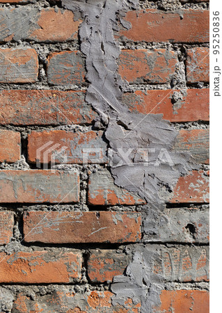 古い、修繕を繰り返したレトロなレンガの塀 95250836