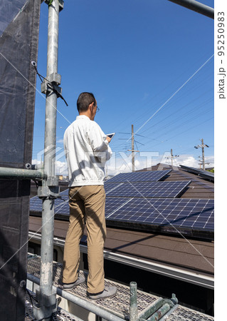 太陽光発電システムを点検している男性 太陽光発電システムを点検している男性 95250983