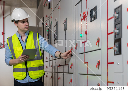 Electrical engineer working in control room. Electrical engineer working in control room. 95251143