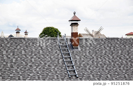 shingle roof. Old method of making roofs from wood, background. Roof ladder and chimney, architectural 95251876