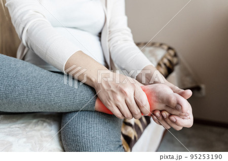 Ankle pain pregnant woman. Pregnancy girl have foot cramp, ankle leg pain doing health massage exercise. Foot swelling during pregnancy. Ankle pain pregnant woman. Pregnancy girl have foot cramp, ankle leg pain doing health massage exercise. Foot swelling during pregnancy. 95253190