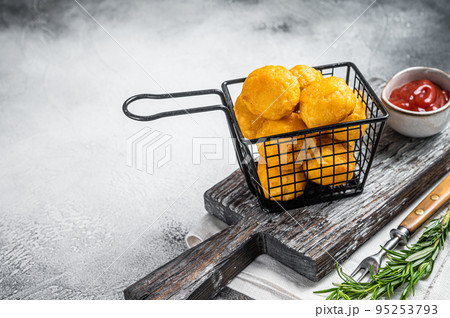 Fried potato cheese balls croquettes with tomato ketchup served in a basket. White background. Top view. Copy space Fried potato cheese balls croquettes with tomato ketchup served in a basket. White background. Top view. Copy space 95253793