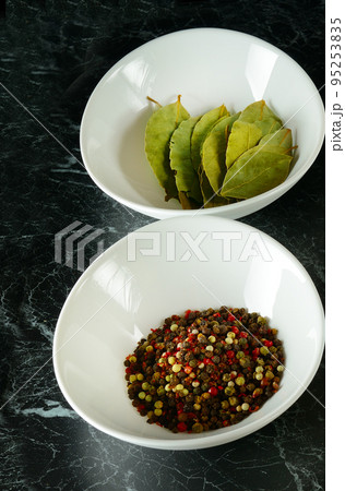 spices in white plates on a black background. Vertical photo. spices in white plates on a black background. Vertical photo. 95253835
