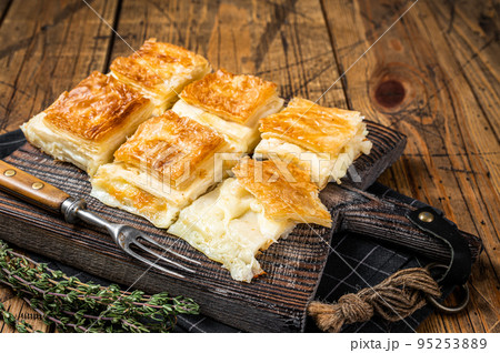 Delicious Turkish Tray pastry, Su boregi with cheese. Wooden background. Top view 95253889