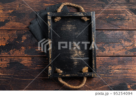 Directly Above view Of wooden tray on dark Table. Wooden background. Top view. Copy space Directly Above view Of wooden tray on dark Table. Wooden background. Top view. Copy space 95254094