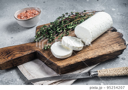 Fresh goat soft cheese with thyme. Gray background. Top view 95254207