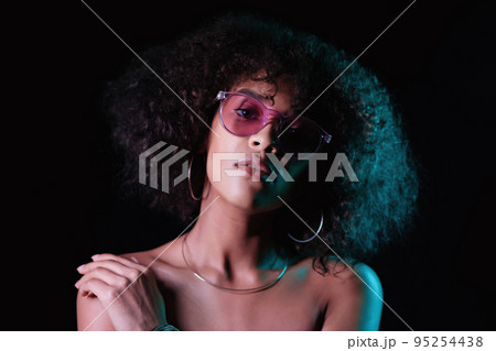 Portrait of young alluring mixed race girl in neon light. Fashion, glamour, model concept. Seductive 95254438