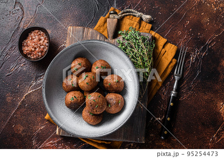 Vegetarian meatless Meatballs from plant based meat with herbs. Dark background. Top view Vegetarian meatless Meatballs from plant based meat with herbs. Dark background. Top view 95254473