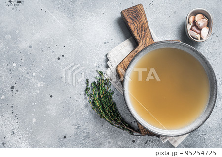 Bone meat chicken broth in a plate. Gray background. Top view. Copy space 95254725