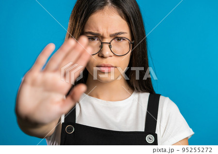 No, never, pretty brunette woman disliking and rejecting gesture by stop sign. Portrait of young 95255272