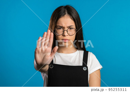 No, never, pretty brunette woman disliking and rejecting gesture by stop sign. Portrait of young 95255311