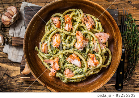 Italian traditional Pasta al Salmone, Bucatini pasta with Smoked Salmon. Wooden background. Top view Italian traditional Pasta al Salmone, Bucatini pasta with Smoked Salmon. Wooden background. Top view 95255505