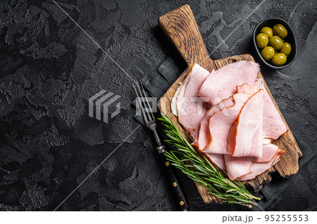 Pork ham slices on cutting board, Italian Prosciutto cotto. Black background. Top view. Copy space Pork ham slices on cutting board, Italian Prosciutto cotto. Black background. Top view. Copy space 95255553