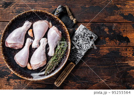Chicken drumsticks legs, raw poultry meat on butcher board. Wooden background. Top view. Copy space Chicken drumsticks legs, raw poultry meat on butcher board. Wooden background. Top view. Copy space 95255564