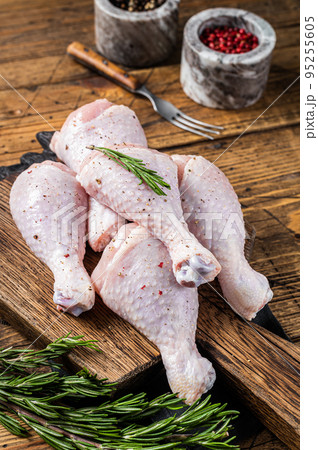 Fresh Chicken drumsticks legs with skin, raw poultry meat. Wooden background. Top view Fresh Chicken drumsticks legs with skin, raw poultry meat. Wooden background. Top view 95255605