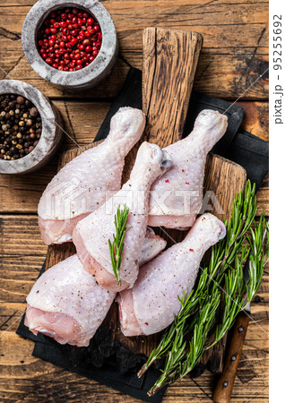 Fresh Chicken drumsticks legs with skin, raw poultry meat. Wooden background. Top view Fresh Chicken drumsticks legs with skin, raw poultry meat. Wooden background. Top view 95255692