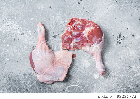 Fresh raw duck legs on a kitchen table. Gray background. Top view 95255772