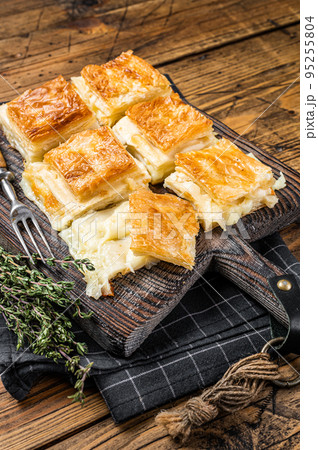 Delicious Turkish Tray pastry, Su boregi with cheese. Wooden background. Top view 95255804