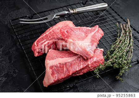 Topside sirloin beef cut, raw meat with spices. Black background. Top view 95255863