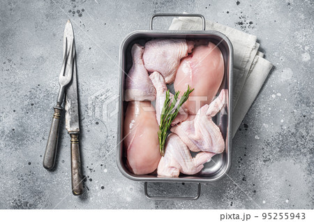 Raw chicken meat parts with spices and rosemary ready for cooking. Gray background. Top view 95255943