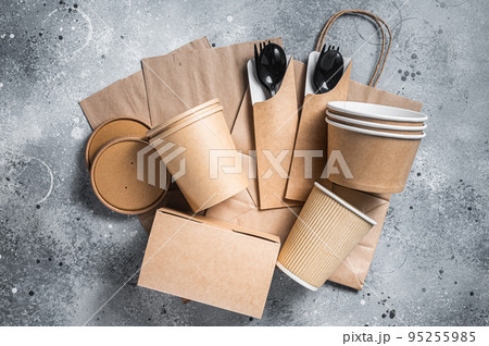 Eco friendly recycling paper tableware. Paper cups, dishes, bag, fast food containers and cutlery. Gray background. Top view. Copy space Eco friendly recycling paper tableware. Paper cups, dishes, bag, fast food containers and cutlery. Gray background. Top view. Copy space 95255985