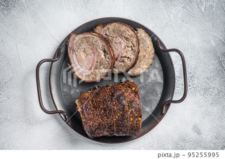 Sliced roast pork meat roulade on a steel tray. White background. Top view Sliced roast pork meat roulade on a steel tray. White background. Top view 95255995