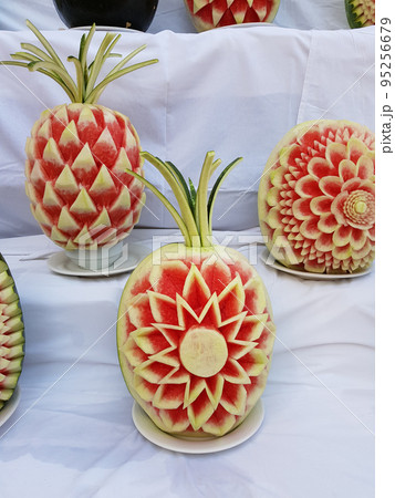 Large fresh watermelons with carved decorations. Decorative watermelon carving 95256679
