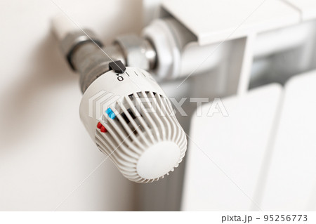 Heating Radiator with turn off position thermostat. Energy crisis concept Heating Radiator with turn off position thermostat. Energy crisis concept 95256773