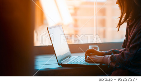 Girl is working on a laptop at home online. Girl is working on a laptop at home online. 95257577