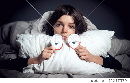 Young scared girl with pillow monster, nightmares. 95257579