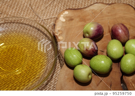 Olives and Olive Oil on wooden background 95259750