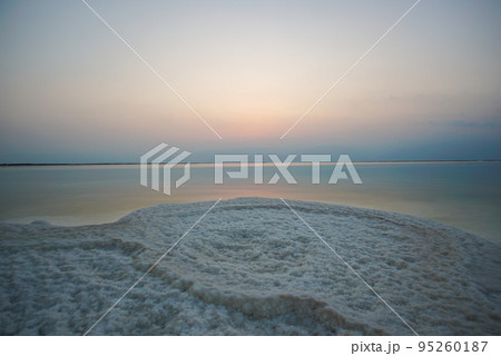 Beautiful sunrise at Dead Sea in Israel with rocks of salt at foreground Beautiful sunrise at Dead Sea in Israel with rocks of salt at foreground 95260187