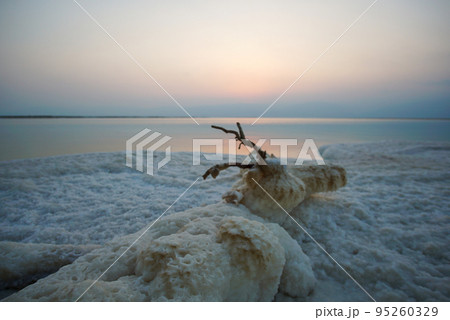 Beautiful sunrise at Dead Sea in Israel with rocks of salt at foreground 95260329