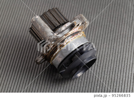 Old car pump on a gray background. The concept of repair and replacement of the pump. Automotive spare part from the cooling system, close-up 95266835