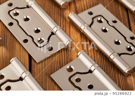 door metal hinges on a wooden background, macro. Door furniture door metal hinges on a wooden background, macro. Door furniture 95266922