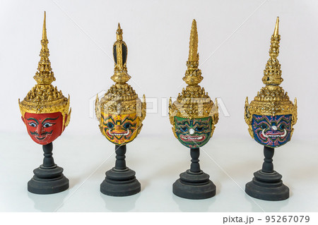 A small red, green, yellow, blue actor's mask is set on a white background. 95267079