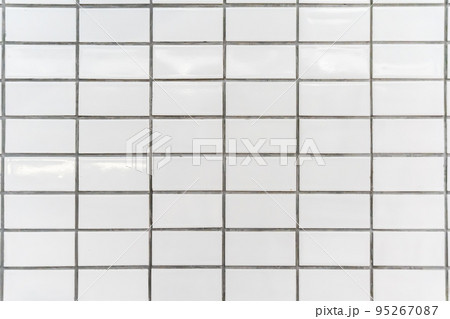 The white tiles on the walls are arranged in an orderly fashion. The white tiles on the walls are arranged in an orderly fashion. 95267087