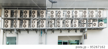 Many air conditioners units compressor are attached to the sides of large buildings for cooling. Many air conditioners units compressor are attached to the sides of large buildings for cooling. 95267162