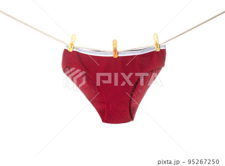 Stylish women's red panties hang on a clothesline after washing. White background, isolate Stylish women's red panties hang on a clothesline after washing. White background, isolate 95267250