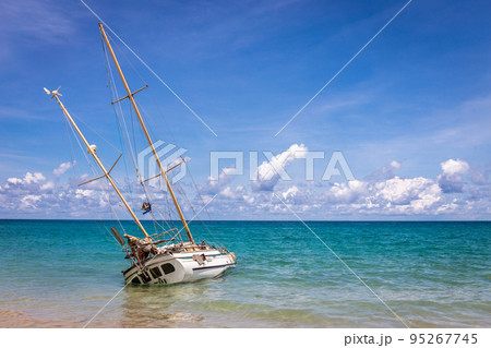 Abandoned shipwreck on the coast at kata beach with blue sky Phuket Thailand, tourist landmark Abandoned shipwreck on the coast at kata beach with blue sky Phuket Thailand, tourist landmark 95267745