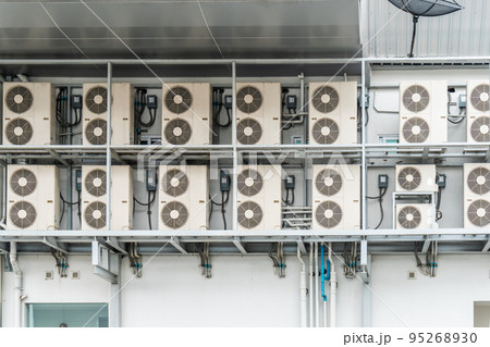 Many air conditioners units compressor are attached to the sides of large buildings for cooling. 95268930