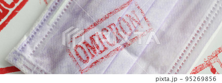 Protective mask with the inscription omicron, close-up 95269856