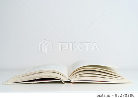 Open book on the table. A book with a white page on a light empty background. Education, school, study, reading concept Open book on the table. A book with a white page on a light empty background. Education, school, study, reading concept 95270386