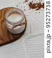 Jars with vegan milk and buckwheat on wooden board. Eco and animal friendly eating concept. Healthy food, diet. Lactose free. Soft focus, blurred background. 95273738