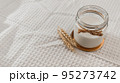 Morning breakfast preparation - making vegan milk. Jar with alternative milk on wooden board. non-allergic, no lactose dairy product. Healthy eating concept. soft focus, copy space. 95273742