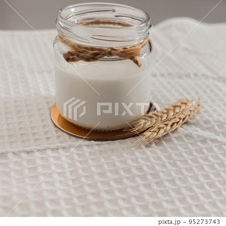 Glass jar with vegan milk, wheat. ingredients for making alternative dairy product. self care concept. healthy eating. no allergy, lactose free. close-up, selective focus 95273743