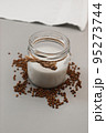 Jar with vegan milk and buckwheat. Eco and animal friendly eating concept. Healthy food, diet. Lactose free. Soft focus. Vertical 95273744