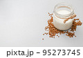 Jar with vegan milk and buckwheat. Eco and animal friendly eating concept. Healthy food, diet. Lactose free. Copy space, soft focus. 95273745