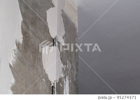 Leveling the walls with a plaster mixture and metal beacons. Plastering of concrete walls during apartment renovation. Copy space for text 95274371