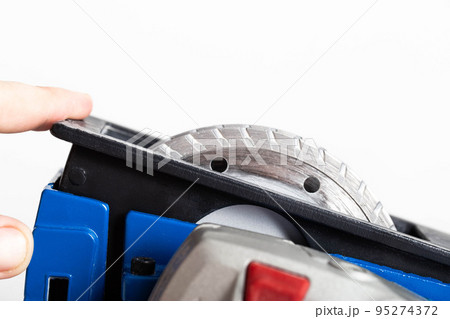 Powerful electric wall chaser for recessing in walls with two diamond blades for reinforced concrete. White background, isolate. Installer's power tool, close-up 95274372